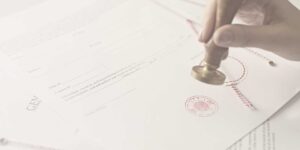 hand stamping a document with a notarial stamp